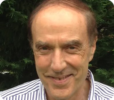 Person standing calmly outdoors, representing presence and sensory awareness practice.