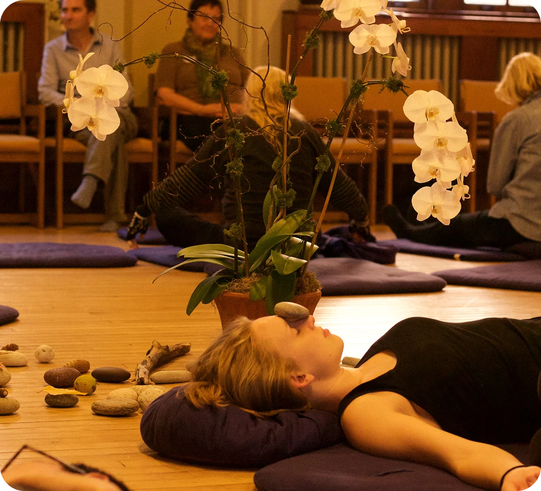 In-person sensory awareness workshop with participants practicing guided awareness together